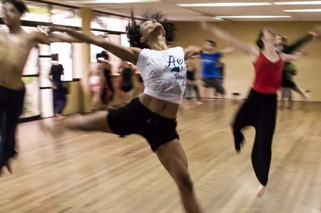 Adults mid-routine at a dance class